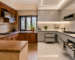 Split-view of a traditional wooden kitchen and a modern modular kitchen in a Kolkata home